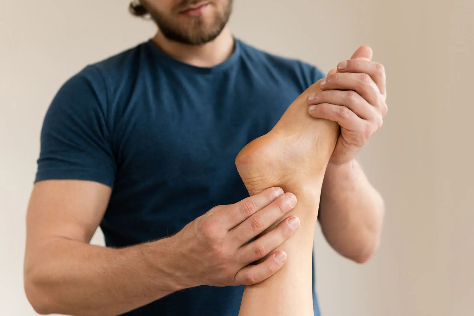 Person experiencing tingling and pins and needles sensations in the feet